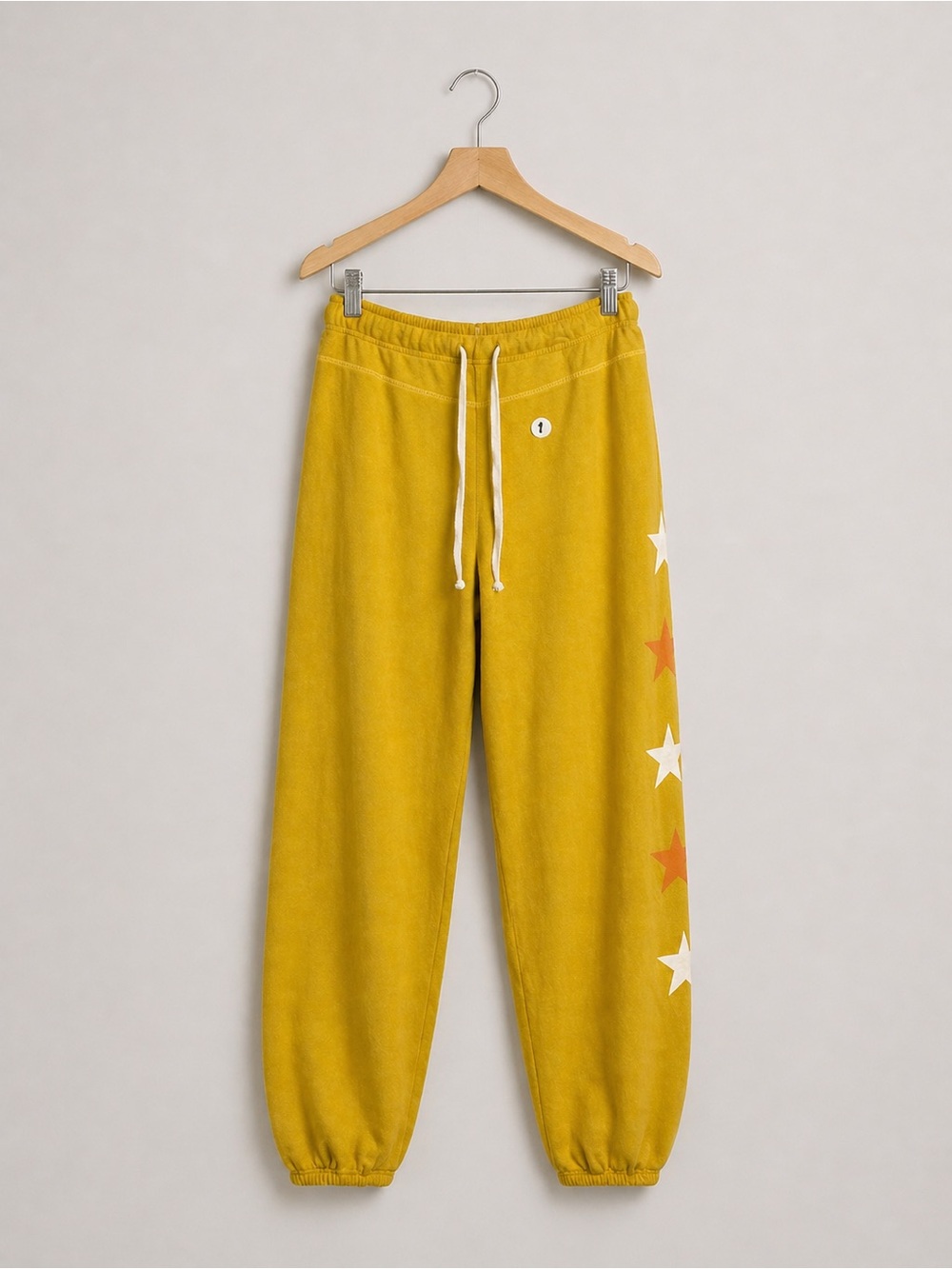 Sundry Anthropologie mustard yellow with orange and white star sweatpants S